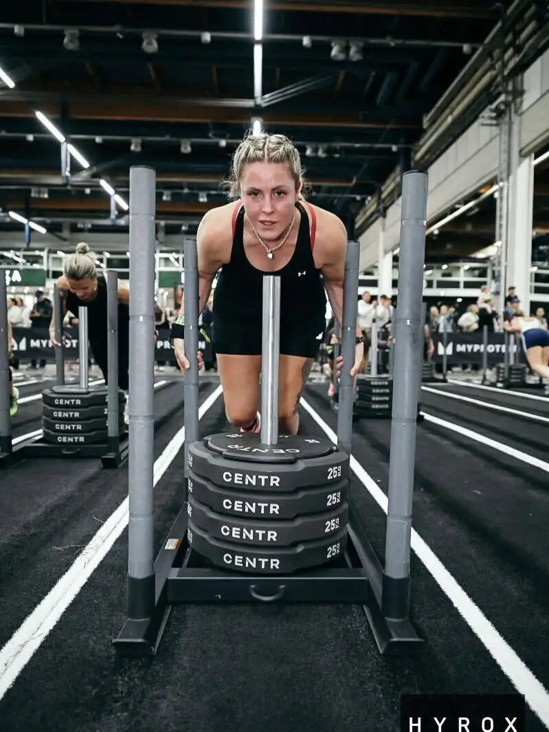 Amy O’Halloran competing in a HYROX sled push